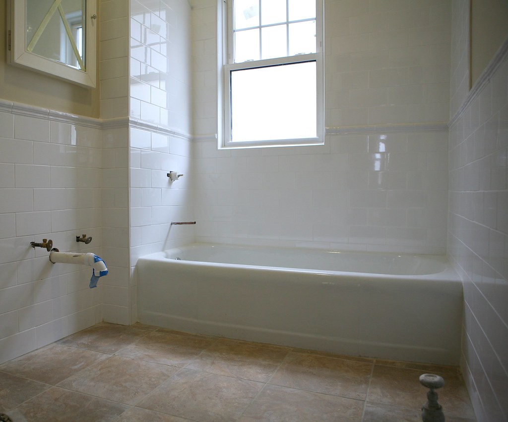 White bathtub with tiled surround